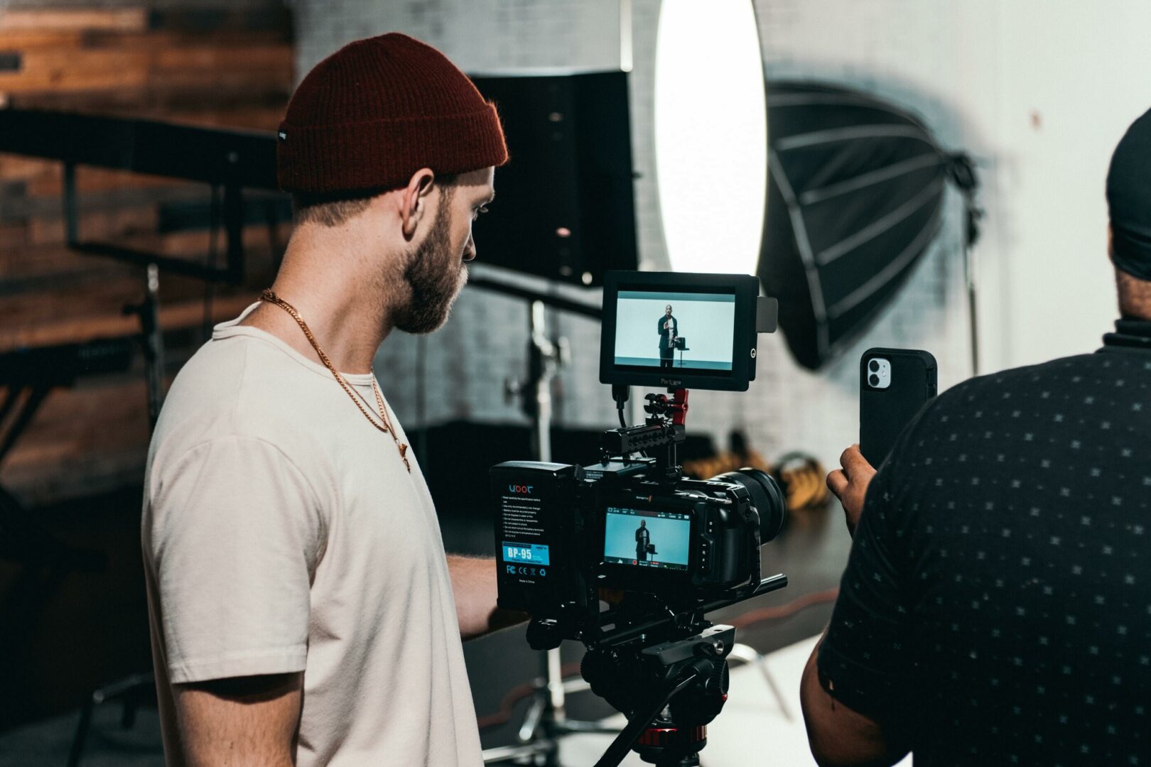 Man working on set in a production using a camera